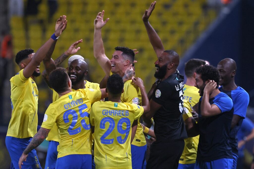 Nassr's Portuguese forward #07 Cristiano Ronaldo (C) celebrates with teammates after scoring their second goal during the Saudi Pro League football match between Al-Nassr and Damac at the King Saud University Stadium in Riyadh on October 21, 2023. (Photo by Fayez NURELDINE / AFP)