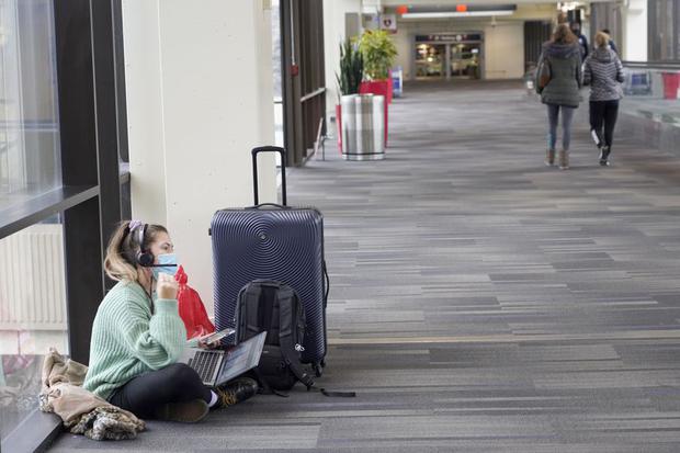 Katelyn Darrow awaits news of her flight at the Philadelphia airport.  (AP / Michael Perez)