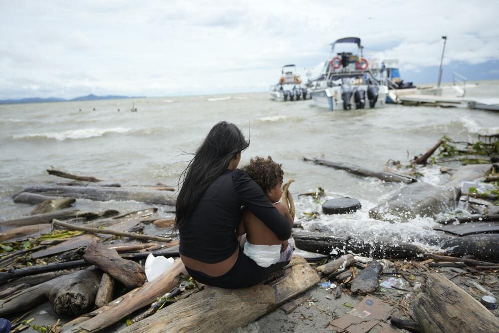 Migrants, mostly Venezuelans, cross the Darién Gap from Colombia to Panama in hopes of reaching the United States, Saturday, Oct. 15, 2022. (AP Photo/Fernando Vergara)