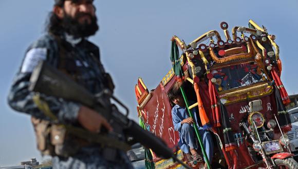 En esta imagen tomada el 3 de octubre de 2021, un combatiente talibán vigila un puesto de control en una carretera en Kabul, Afganistán. (WAKIL KOHSAR / AFP).