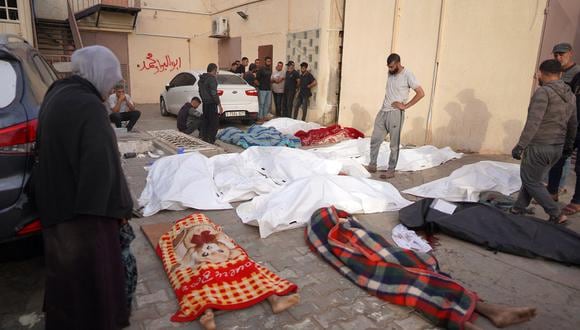 Palestinos rodean los cuerpos de las personas muertas en los bombardeos israelíes, en el patio del Hospital de los Mártires de Al-Aqsa en Deir al-Balah, en el centro de la Franja de Gaza, el 11 de mayo de 2024. (Foto de AFP)