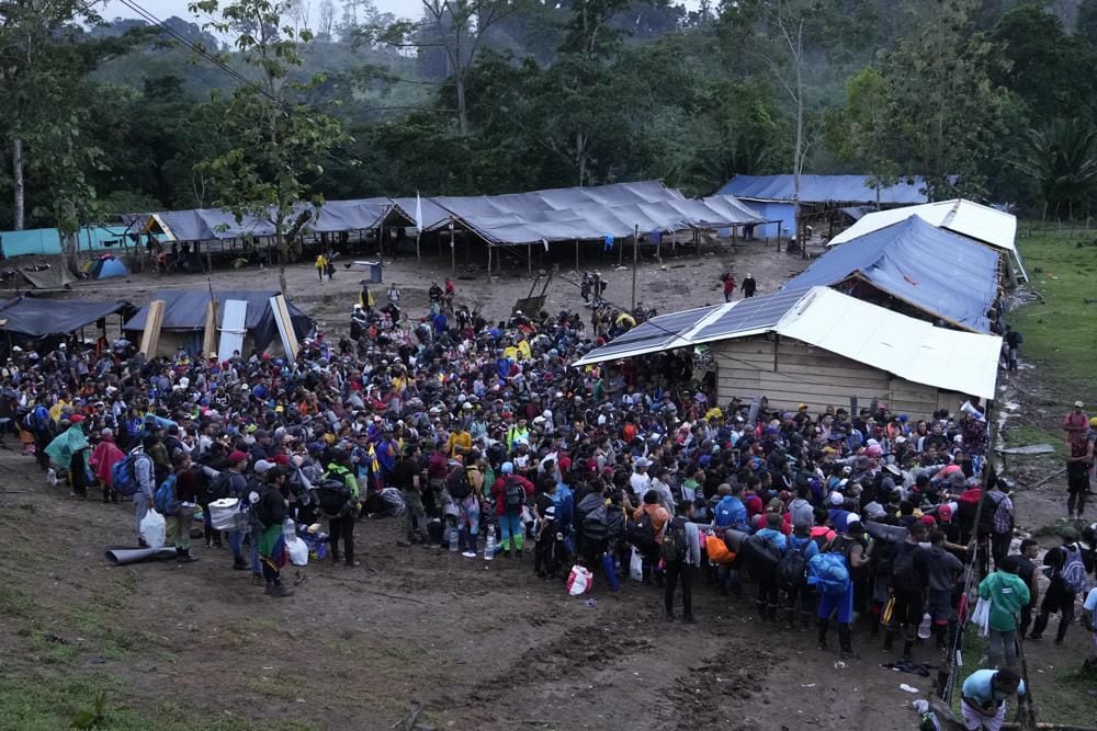 Migrants, mostly Venezuelans, cross the Darién Gap from Colombia to Panama in hopes of reaching the United States, Saturday, Oct. 15, 2022. (AP Photo/Fernando Vergara)