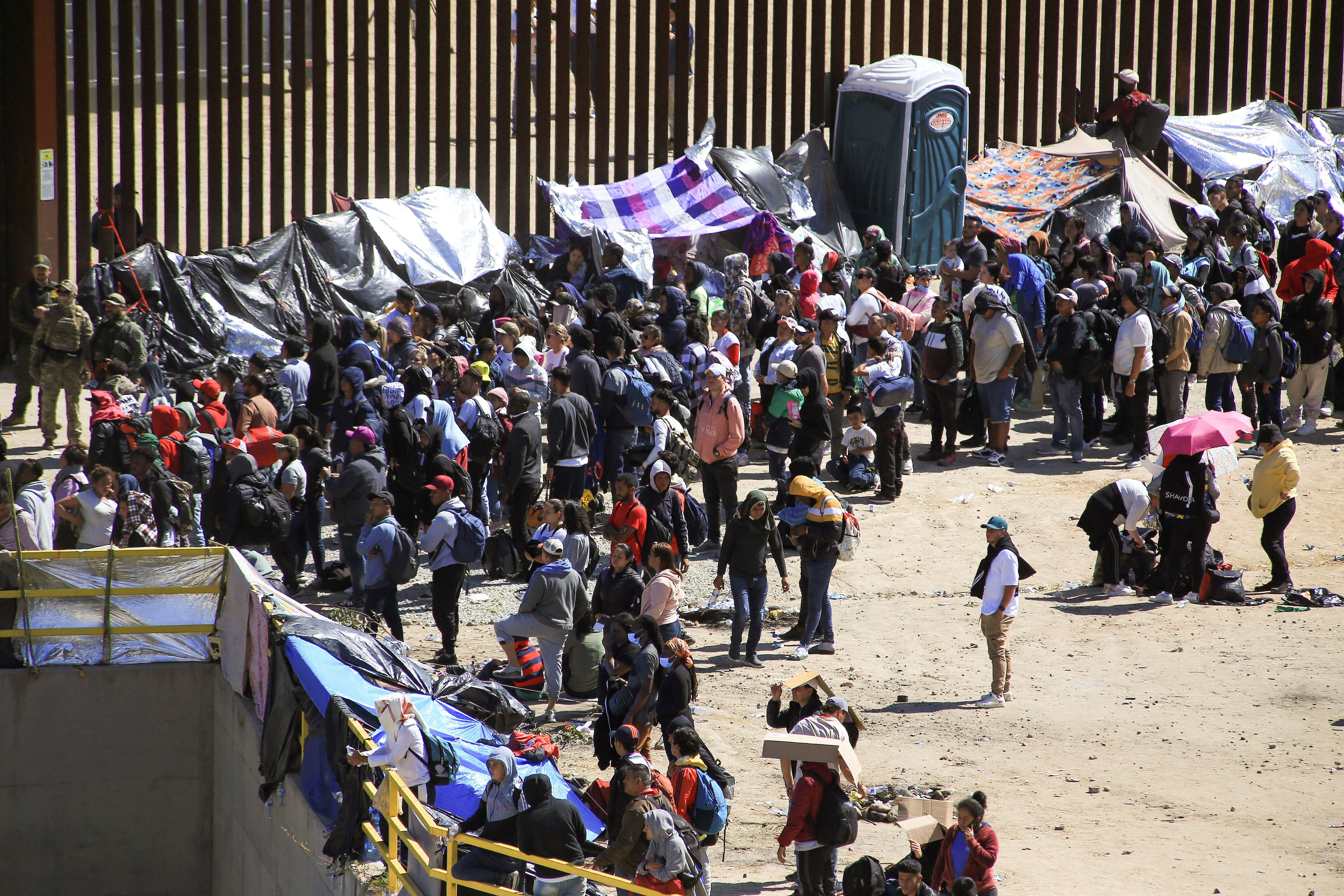 Large groups of migrants also register at the San Diego border crossing before the policy changes.