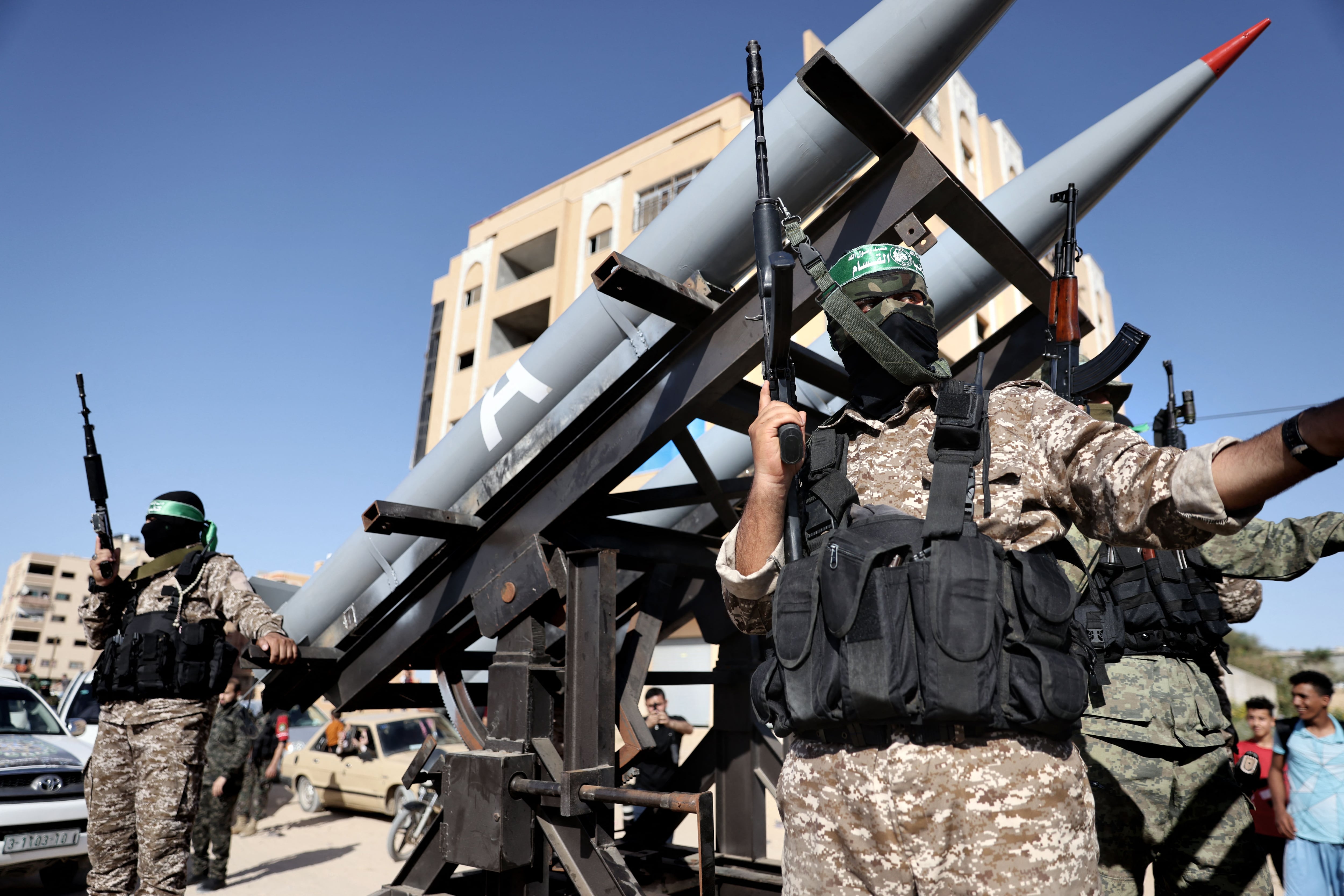 Members of the Ezz-Al Din Al-Qassam Brigades, the armed wing of the Hamas movement, parade in a truck with rockets in Khan Yunis, in the south of the Gaza Strip, on May 27, 2021. (Photo by THOMAS COEX / AFP) .