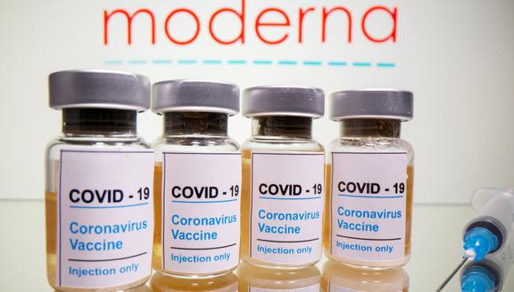 En esta ilustración tomada el 31 de octubre de 2020, se ven viales con una etiqueta que dice "COVID-19 / Vacuna contra el coronavirus / Inyección solamente" y una jeringa médica frente a un logotipo de Moderna. (REUTERS/Dado Ruvic).
