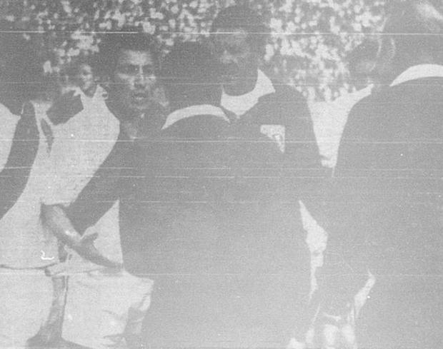 Chechelev takes refuge behind his linesmen against the angry claims of José Fernández and other Peruvian players after disallowing a legitimate goal from Alberto Gallardo.  (Photo: GEC Historical Archive)