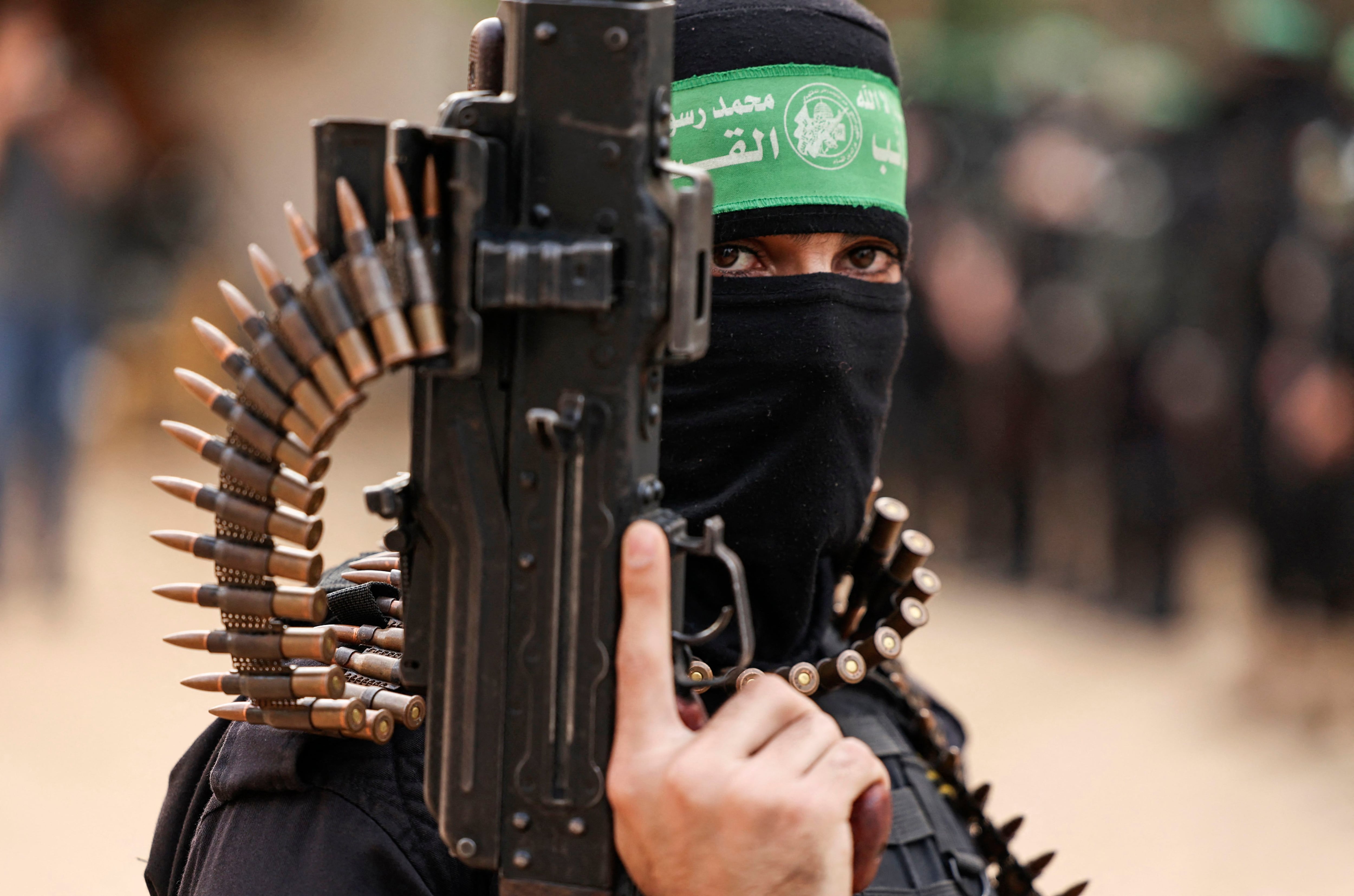 A member of the Ezzedine al-Qassam Brigades, the military wing of the Palestinian movement Hamas, takes part in a parade in Gaza City on November 14, 2021. (Photo by MAHMUD HAMS/AFP).