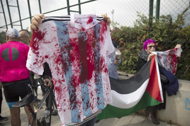 Con camisetas que simulan estar ensangrentadas, manifestantes reclamaron contra el partido en Israel. ("La Nación" de Argentina, GDA).