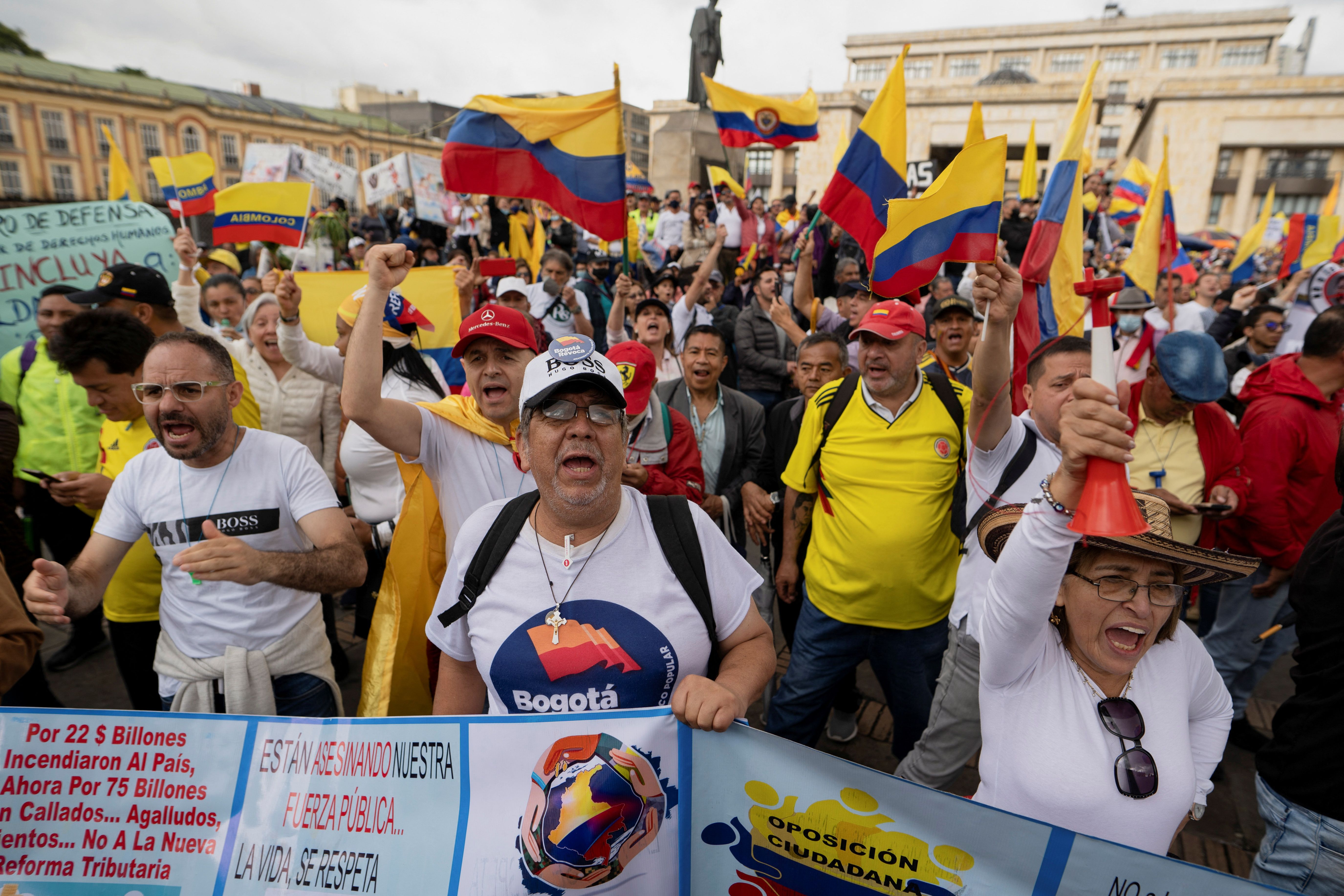 People march to protest against a tax reform proposed by the government of leftist President Gustavo Petro, in Cali, Colombia.
