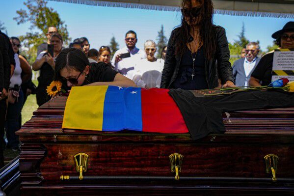 Widow and sister of Ronald Ojeda during his funeral in Chile.  (AP Photo/Esteban Félix).