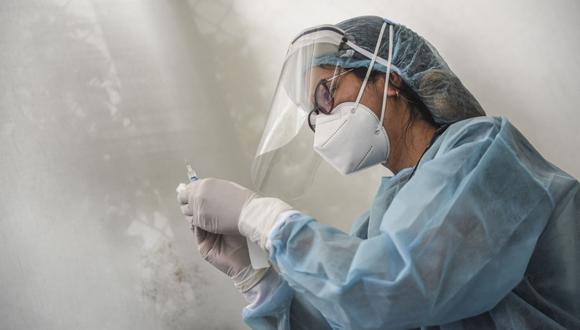 Un trabajador de salud prepara una jeringa para inocular a un voluntario con una vacuna COVID-19 producida por el chino Sinopharm durante su ensayo en el Centro de Estudios Clínicos de la Universidad Cayetano Heredia en Lima el 09 de diciembre de 2020 (Foto: Ernesto Benavides / AFP)