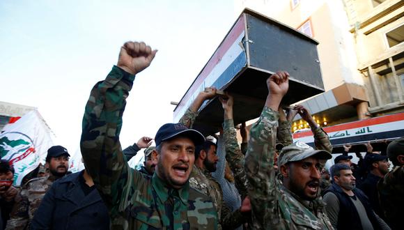 Paramilitares llevan ataúdes de miembros de la milicia Kataeb Hezbollah que fueron asesinados por ataques aéreos estadounidenses en el distrito de Qaim a fines de diciembre. (REUTERS / Alaa al -Marjani).