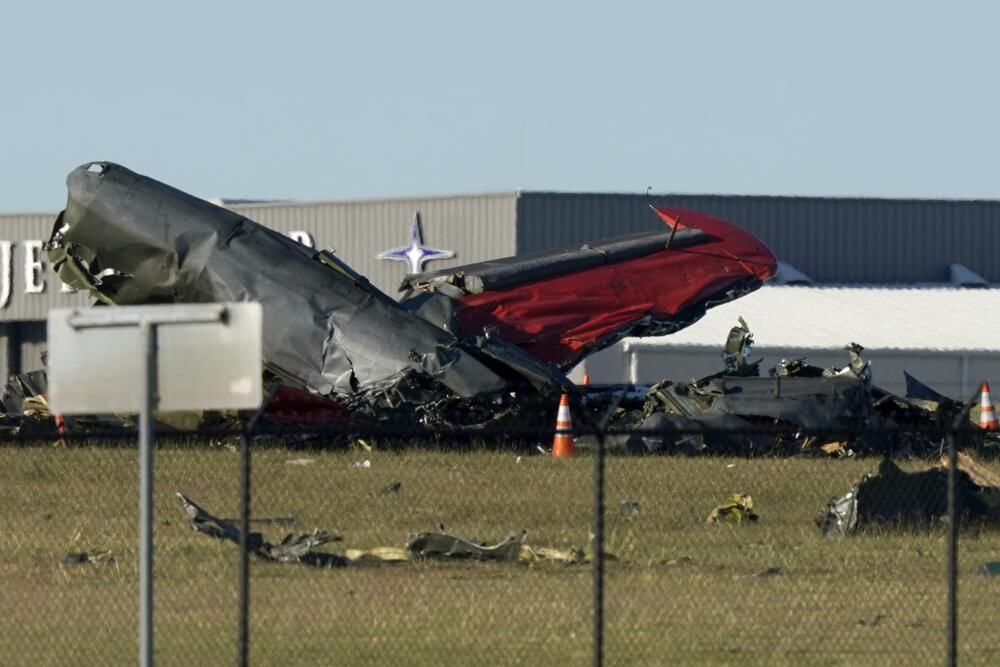 Debris from two planes that crashed during an air show at Dallas Executive Airport lie on the ground Saturday, Nov. 12, 2022. (AP Photo/LM Otero)