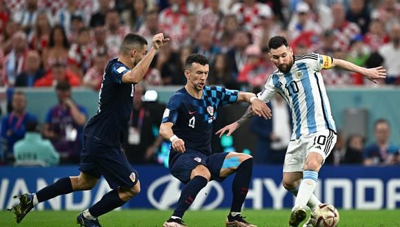 Argentina's forward #10 Lionel Messi (R) fights for the ball with Croatia's midfielder #04 Ivan Perisic (C) during the Qatar 2022 World Cup football semi-final match between Argentina and Croatia at Lusail Stadium in Lusail, north of Doha on December 13, 2022. (Photo by Anne-Christine POUJOULAT / AFP)
