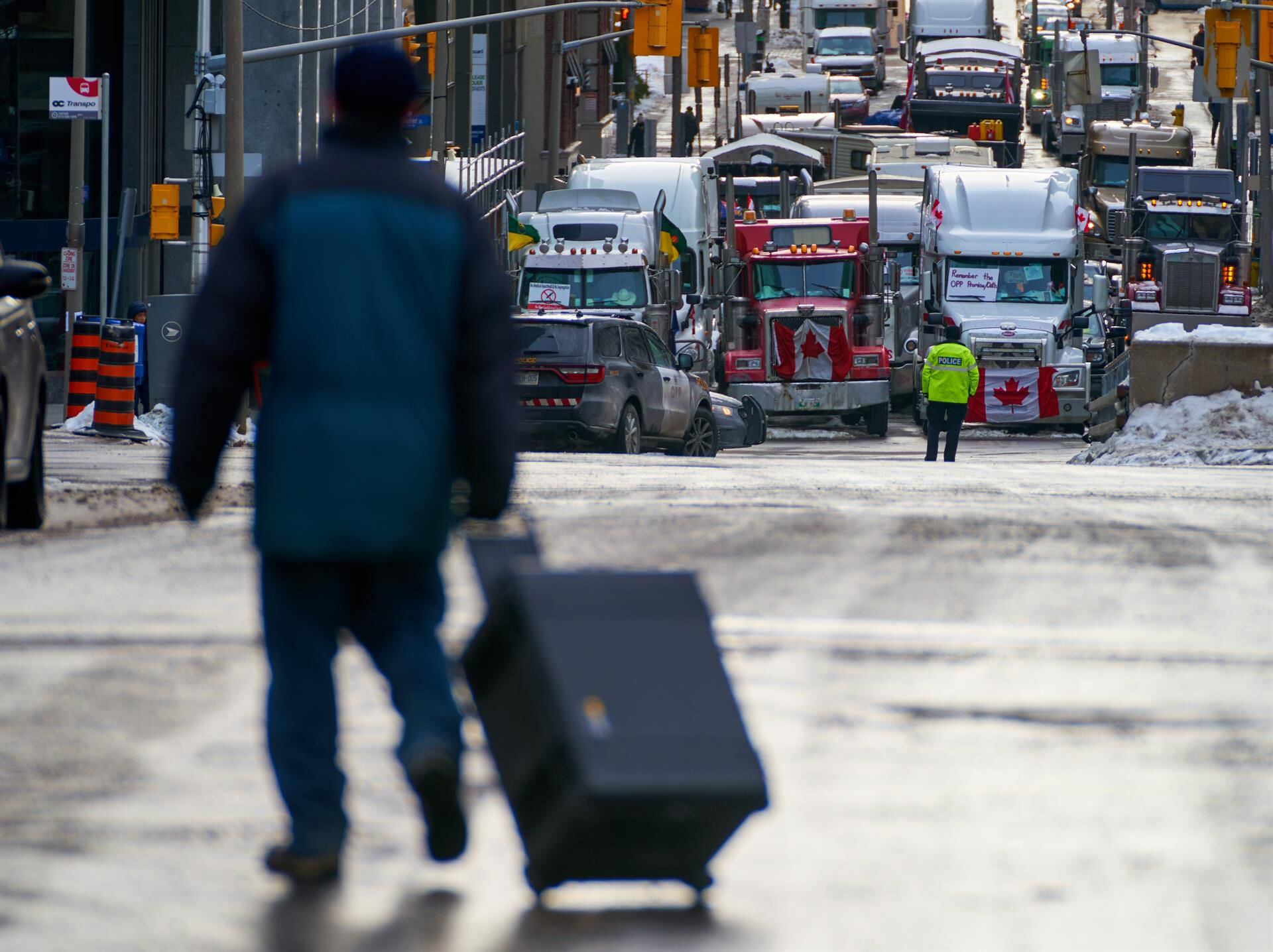 A man walks down a street as truckers continue to protest vaccination mandates.  (EFE/EPA/ANDRE PICHETTE).