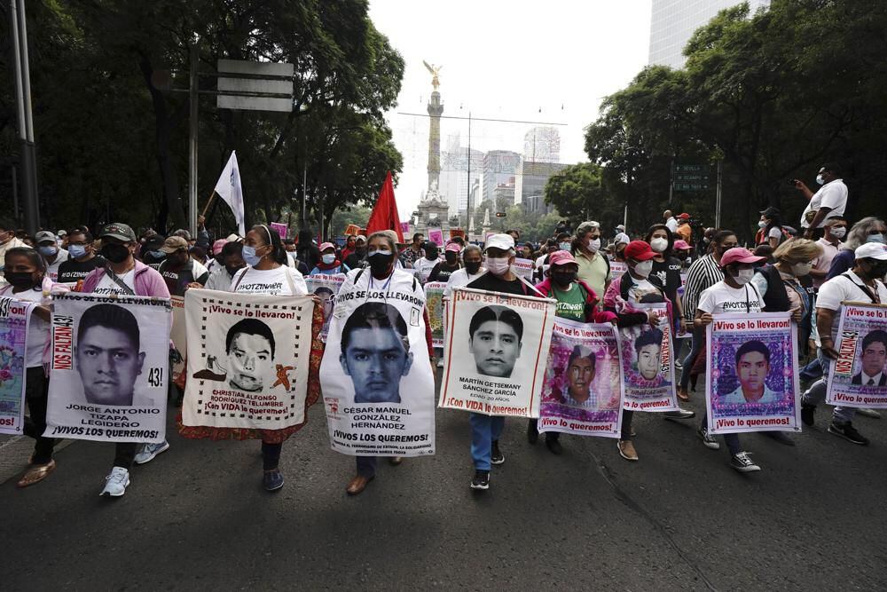 Protesters march in Mexico City on Sunday, September 26, 2021, marking the seventh anniversary of the disappearance of 43 Ayotzinapa students.  (AP Photo/Marco Ugarte).