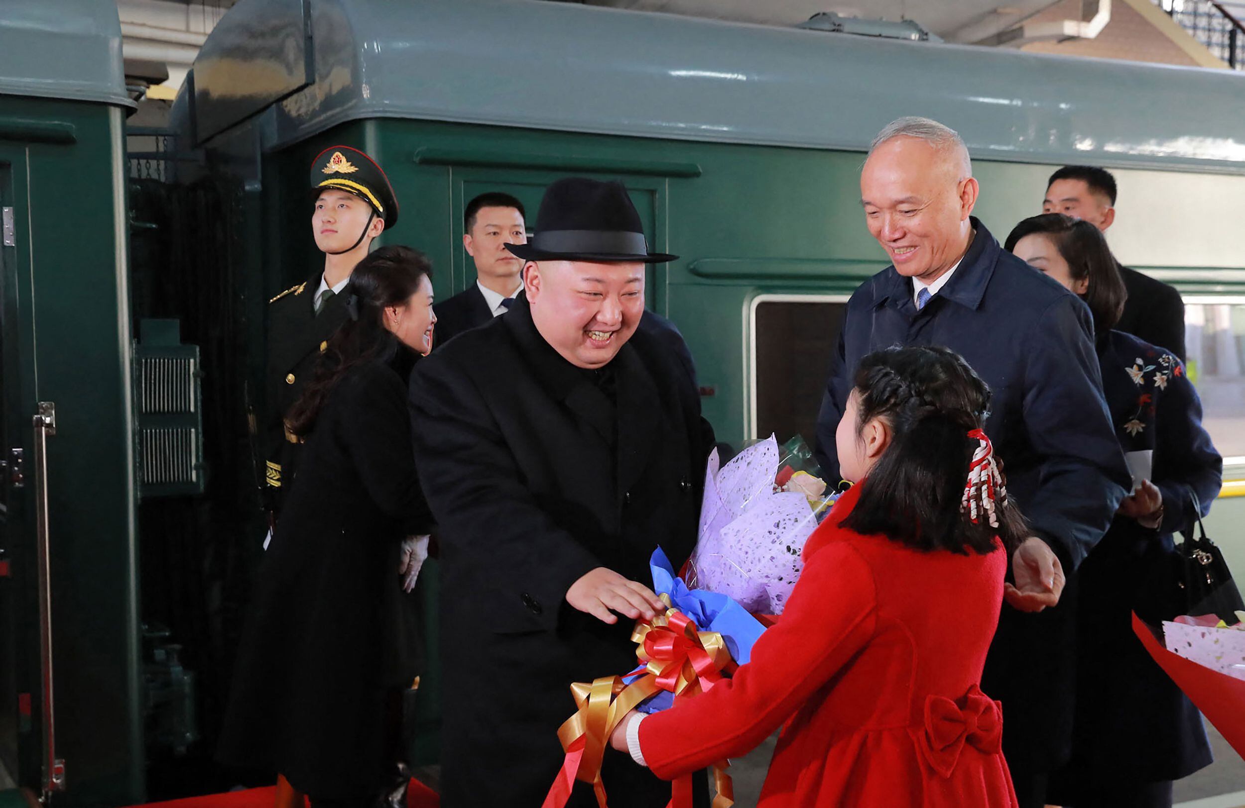 Kim Jong-un receives a bouquet of flowers from a Chinese girl upon his arrival at the Beijing train station.  (Photo by KCNA VIA KNS / KCNA VIA KNS / AFP).