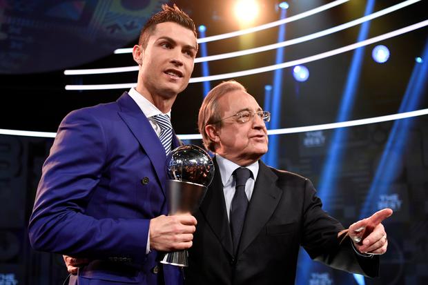 Real Madrid and Portugal's forward and winner of The Best FIFA Men??s Player of 2016 Award Cristiano Ronaldo (L) poses on stage with his trophy next to Real Madrid President Florentino Perez following The Best FIFA Football Awards 2016 ceremony, on January 9, 2017 in Zurich. (Photo by Fabrice COFFRINI / AFP)