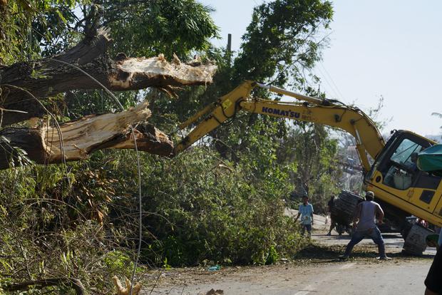 Workers clear a road from downed trees after Typhoon Rai in Talisay, Cebu province, central Philippines.  (Photo: AP / Jay Labra)