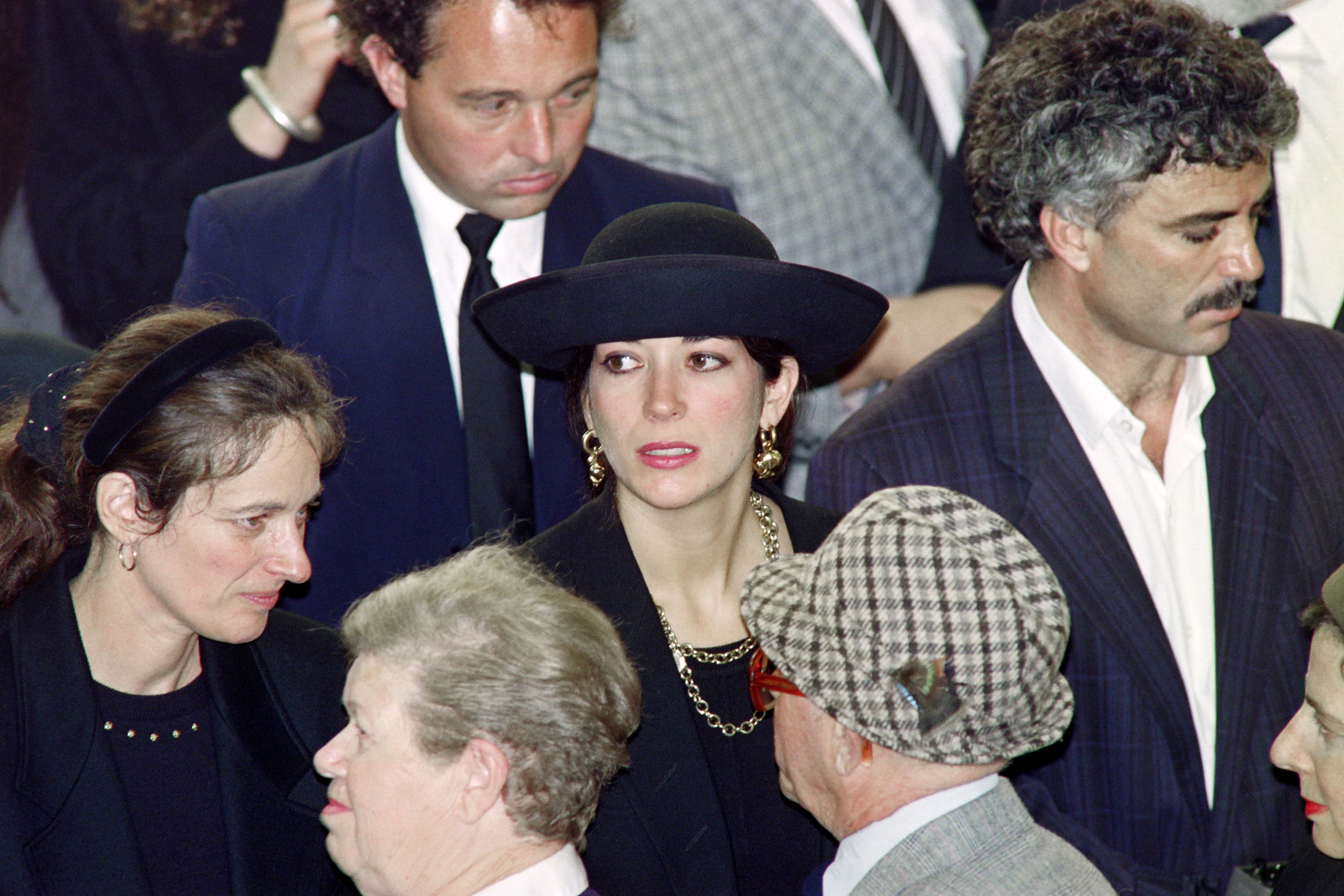 In this file photo taken on November 10, 1991, Ghislaine Maxwell (center) attends her father's funeral service.  (Sven NACKSTRAND / AFP).